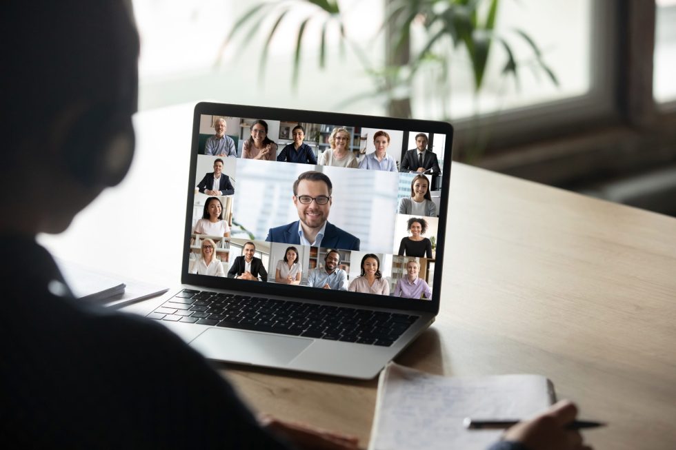 Back,View,Of,Female,Employee,Engaged,In,Team,Webcam,Conference